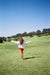 Woman wearing white sweater against a green background