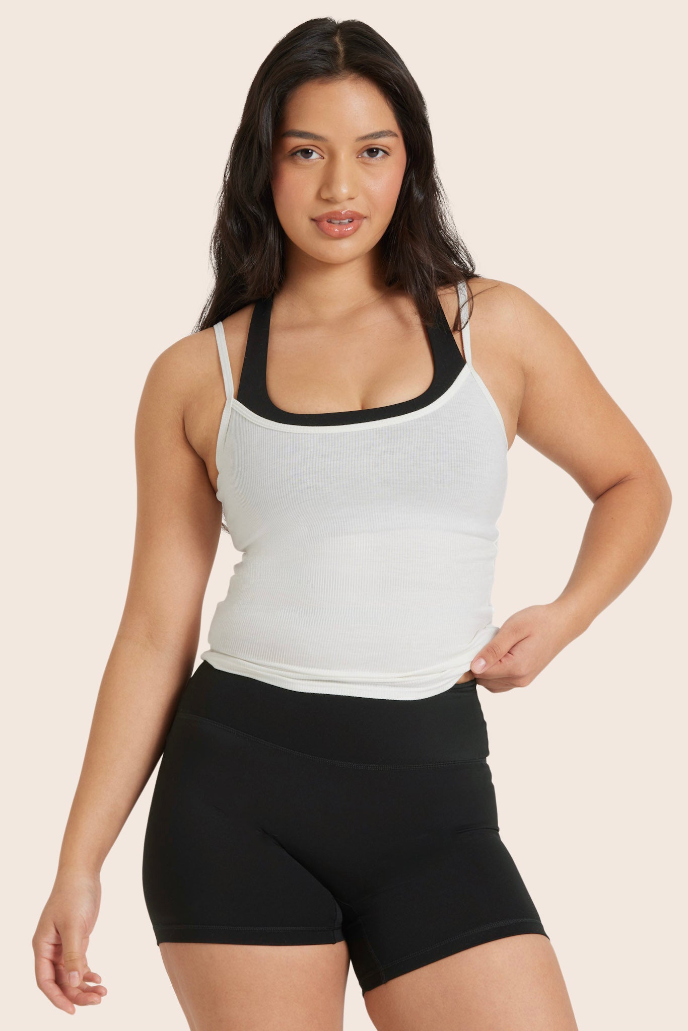 MODEL WEARS SPORTBODY® LAYERED CAMI BRA IN ONYX