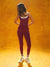 Person wearing a red athletic outfit on an orange background