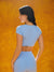 Woman wearing a light blue athletic outfit against an orange background