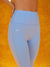 Light blue leggings with 'SET' branding on an orange background