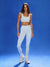 Woman wearing a light blue athletic outfit on a blue background