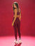 Woman in maroon athletic outfit standing against a red background