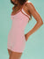 Woman wearing a pink romper with thin straps against a light blue background <model-info>Logan wears a size XS and is 5’9½”, 24” waist, 32B bust.</model-info>