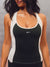 A woman wearing a sleeveless athletic tank top with a black body, white shoulder panels, and white trim, featuring the brand name 'SET' printed in white on the chest. <model-info>Alana wears a size M and is 5’8”, 28” waist, 35" bust.</model-info>