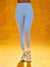 Person wearing light blue leggings and white sneakers on a yellow background