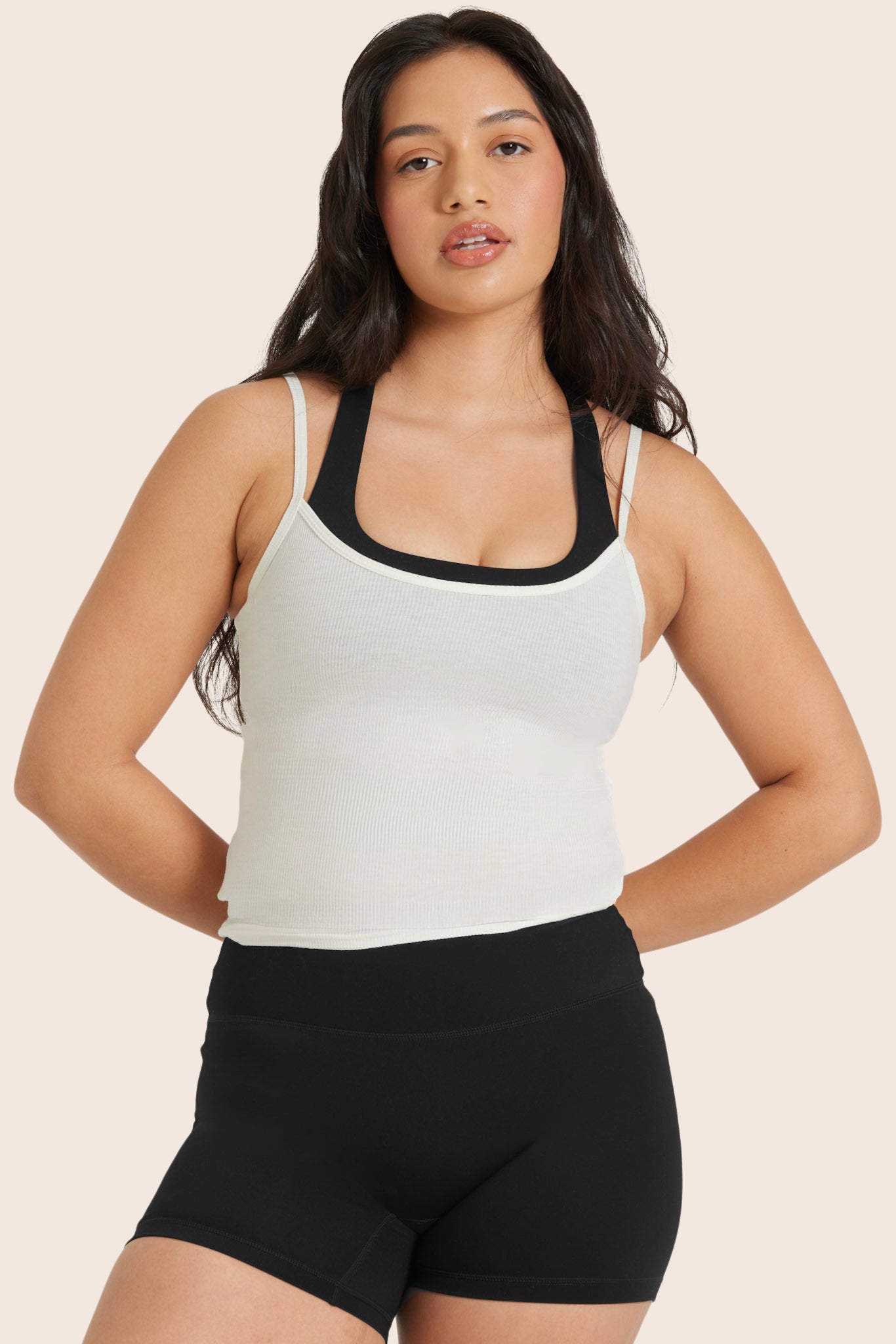 MODEL WEARS SPORTBODY® LAYERED CAMI BRA IN ONYX