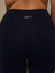 Close-up back view of a person wearing dark navy high-waisted leggings with the brand name 'SET' printed in white on the waistband.