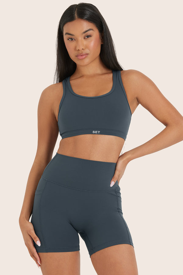 MODEL WEARS AIRLUXE™ BREATHE FLEX BRA IN COMPASS 