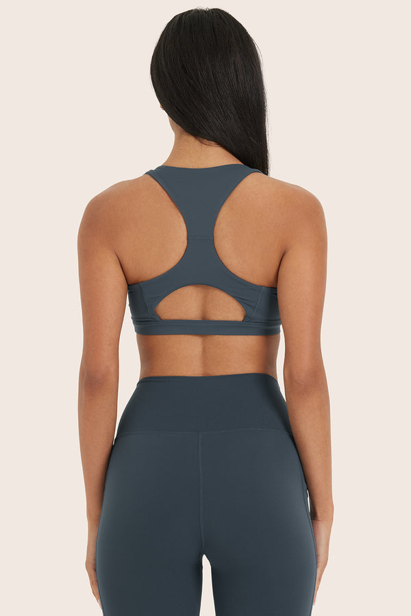 MODEL WEARS AIRLUXE™ BREATHE TRACK BRA IN COMPASS 