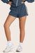 MODEL WEARS NYLON TRACK SHORTS IN COASTAL <model-info>Athena wears a size XS and is 5' 6", 25.5" waist, 36.5" bust.</model-info>