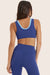 Model wears BREATHE LAYER SCOOP BRA in BETTA 