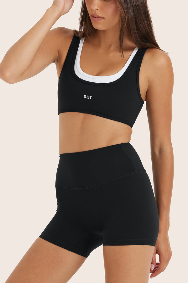 Model wears BREATHE LAYER SCOOP BRA in ORCA 