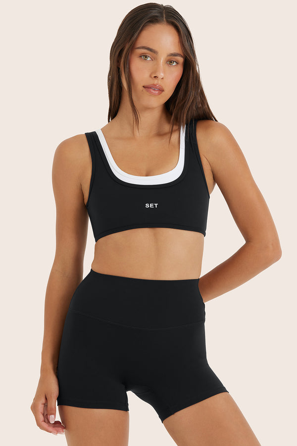 Model wears BREATHE LAYER SCOOP BRA in ORCA 