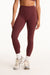 Maroon leggings worn by a person on a white background <model-info>Presley wears a size S and is 5’6”, 26” waist, 33” bust.</model-info>