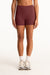 Person wearing maroon shorts on a white background <model-info>Presley wears a size S and is 5’6”, 26” waist, 33” bust.</model-info>
