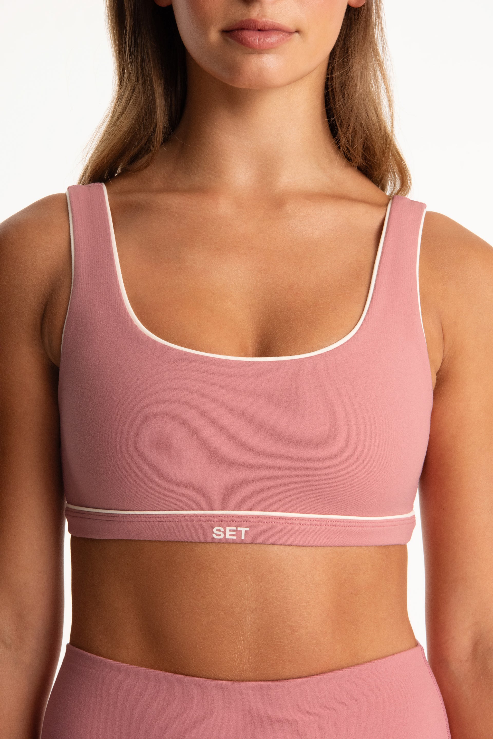 Pink sports bra with 'SET' branding on a plain background