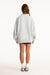 Person wearing a light gray oversized sweatshirt on a white background