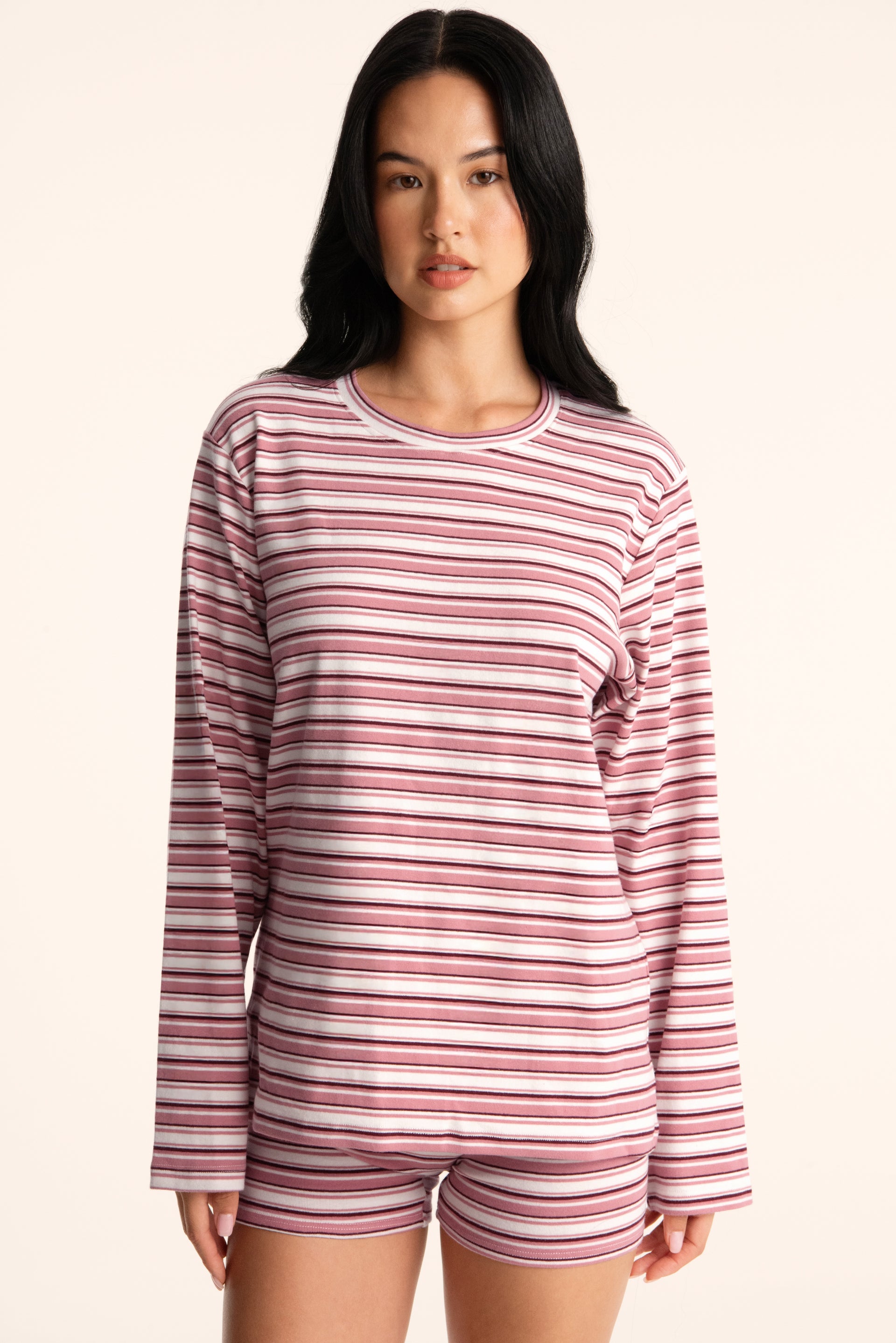 Woman wearing a striped long-sleeve top and shorts on a beige background <model-info>Jasmine wears a size S and is 5’8”, 25" waist, 36” bust.</model-info>