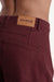 Maroon pants with a visible 'Parke' brand label on a white background