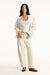 Woman wearing a white outfit on a white background