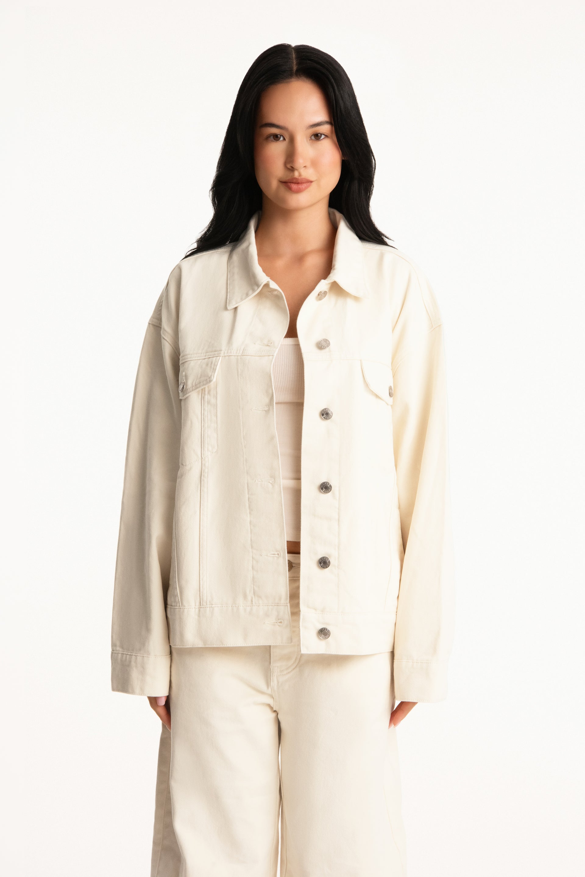 Woman wearing a beige jacket and pants on a white background <model-info>Jasmine wears a size S/M and is 5’8”, 25" waist, 36” bust.</model-info>