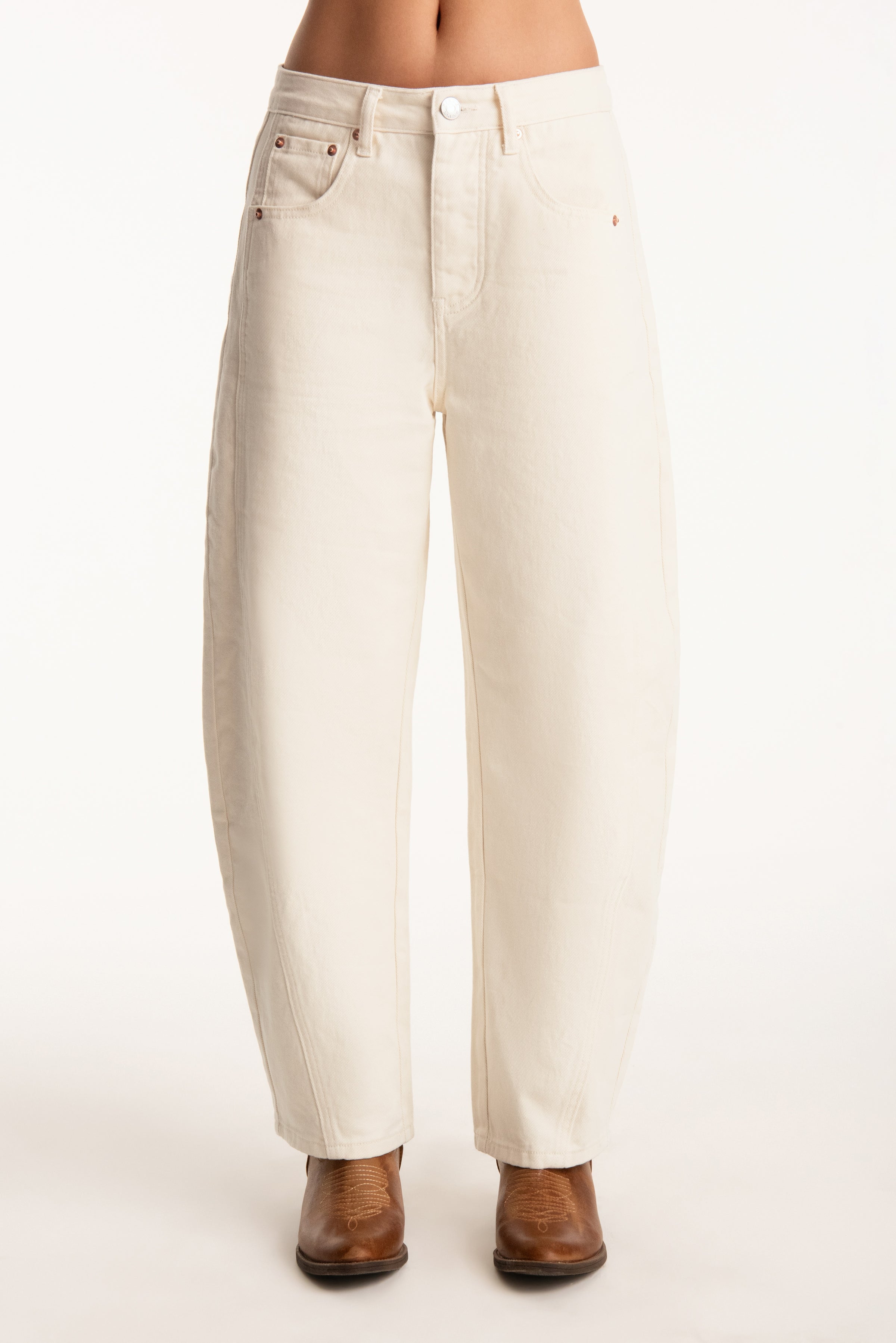 White jeans worn by a person on a white background 