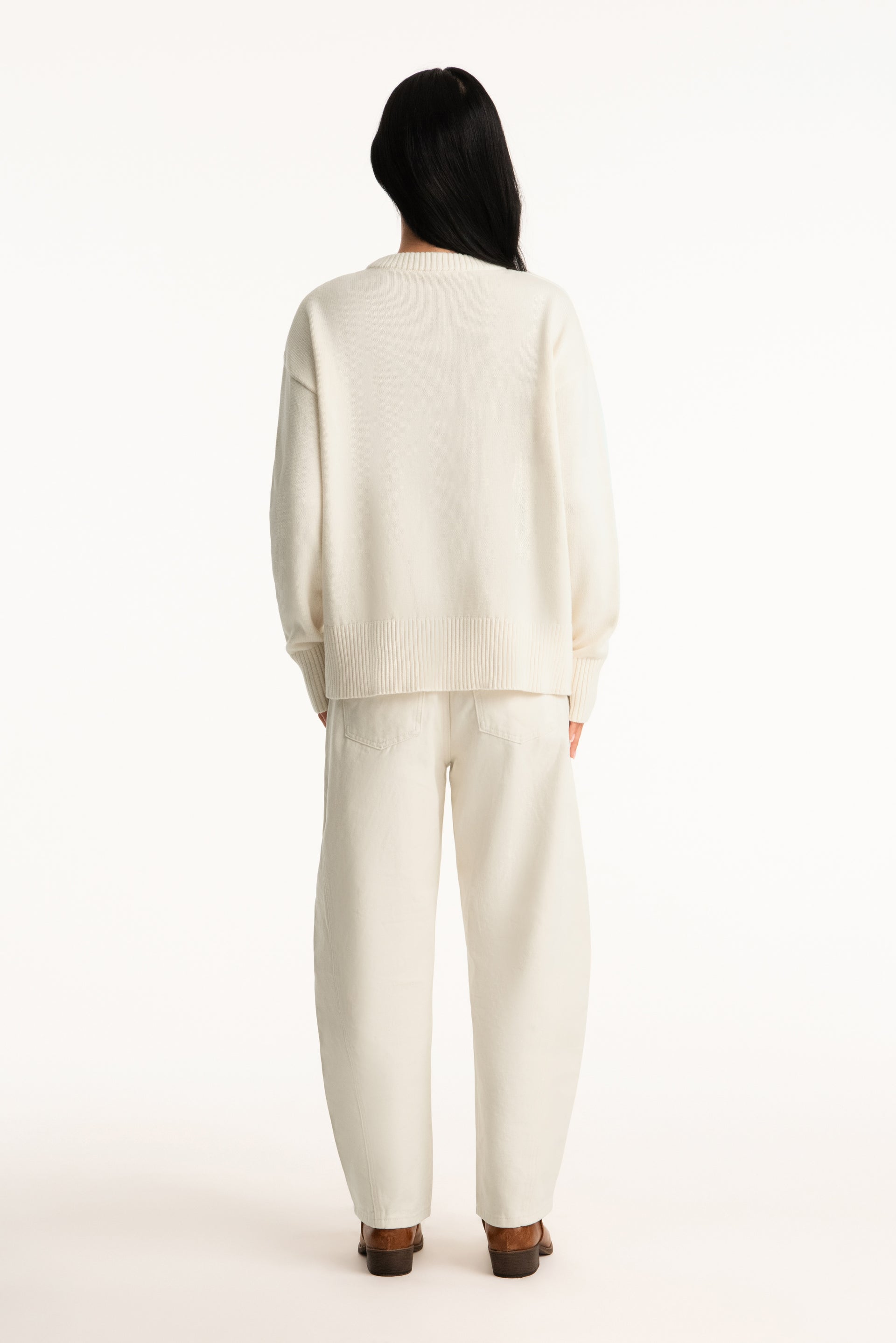 Person wearing a white outfit on a white background