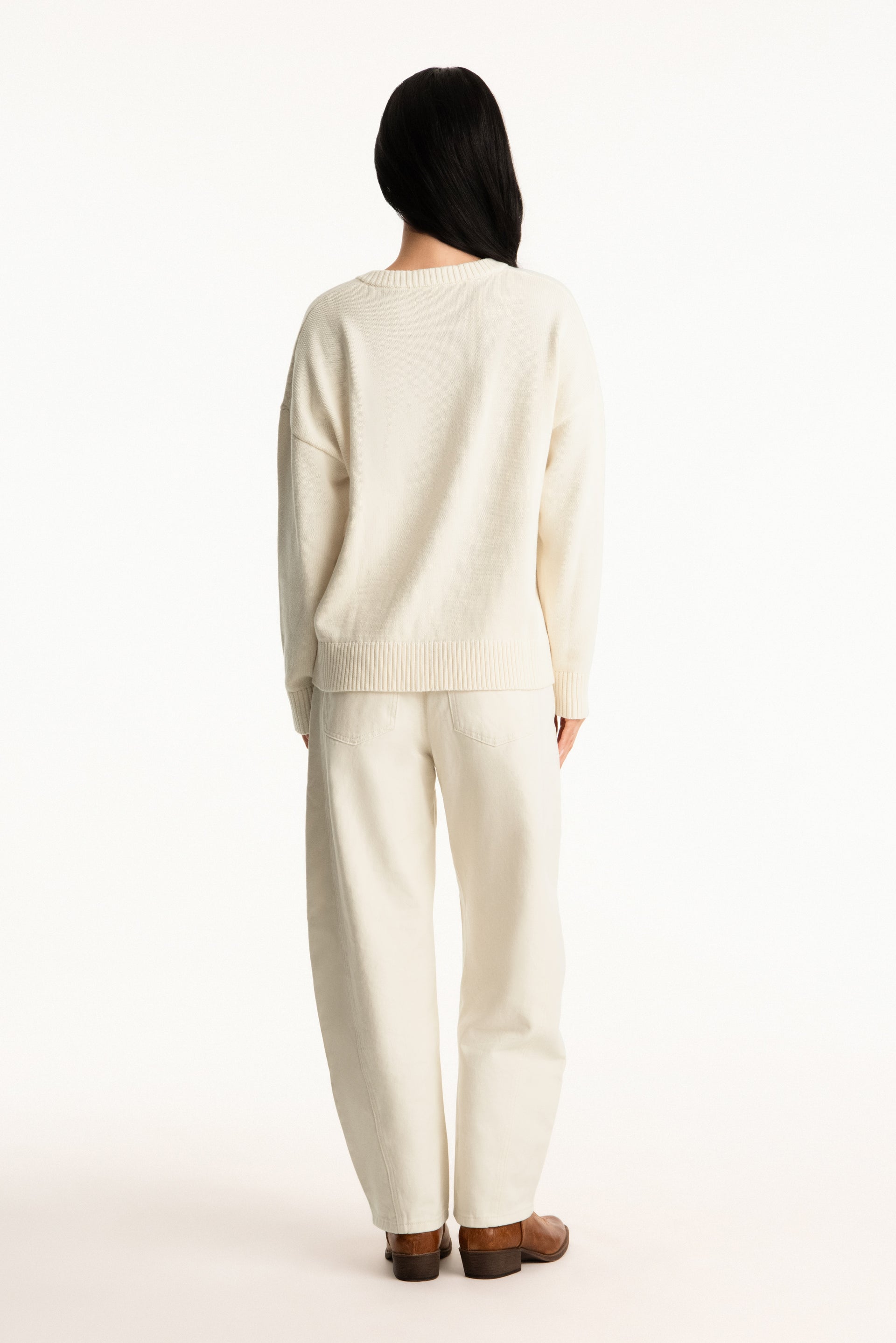 Person wearing a beige outfit on a white background