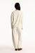 Person wearing a beige outfit on a white background