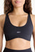 Black sports bra with 'SET' logo worn by a person on a white background