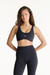 Woman wearing a black sports bra and leggings with 'SET' branding on a white background <model-info>Jana wears a size S and is 5’4½”, 24” waist, 33½” bust.</model-info>