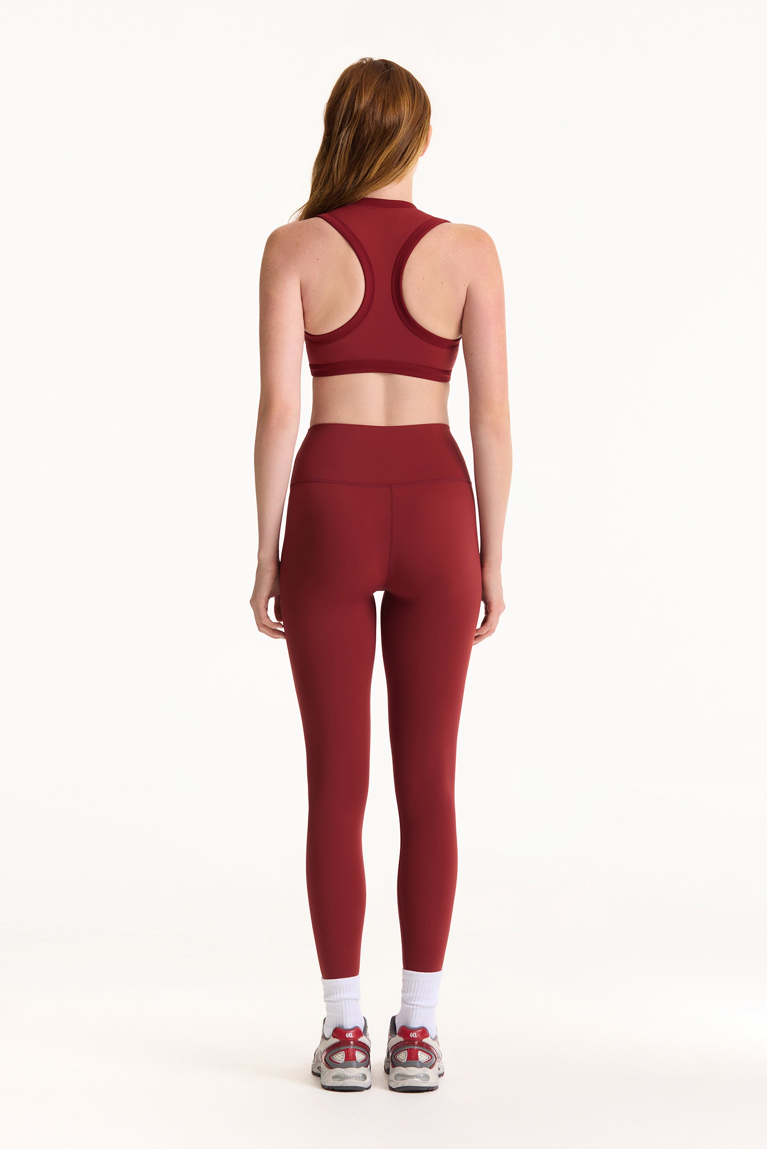 Person wearing a red athletic outfit on a white background