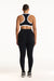 Person wearing a black sports bra and leggings set on a white background
