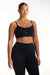 Woman wearing a black sports bra and leggings on a white background <model-info>Jade wears a size L and is 5’9”, 30” waist, 38” bust.</model-info>