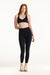 Woman wearing a black sports bra and leggings on a white background