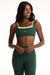 Woman wearing a green sports bra and leggings with a white background <model-info>Autumn wears a size S and is 5’7½“, 25" waist, 32" bust.</model-info>