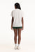 Person wearing a white t-shirt and green shorts on a white background