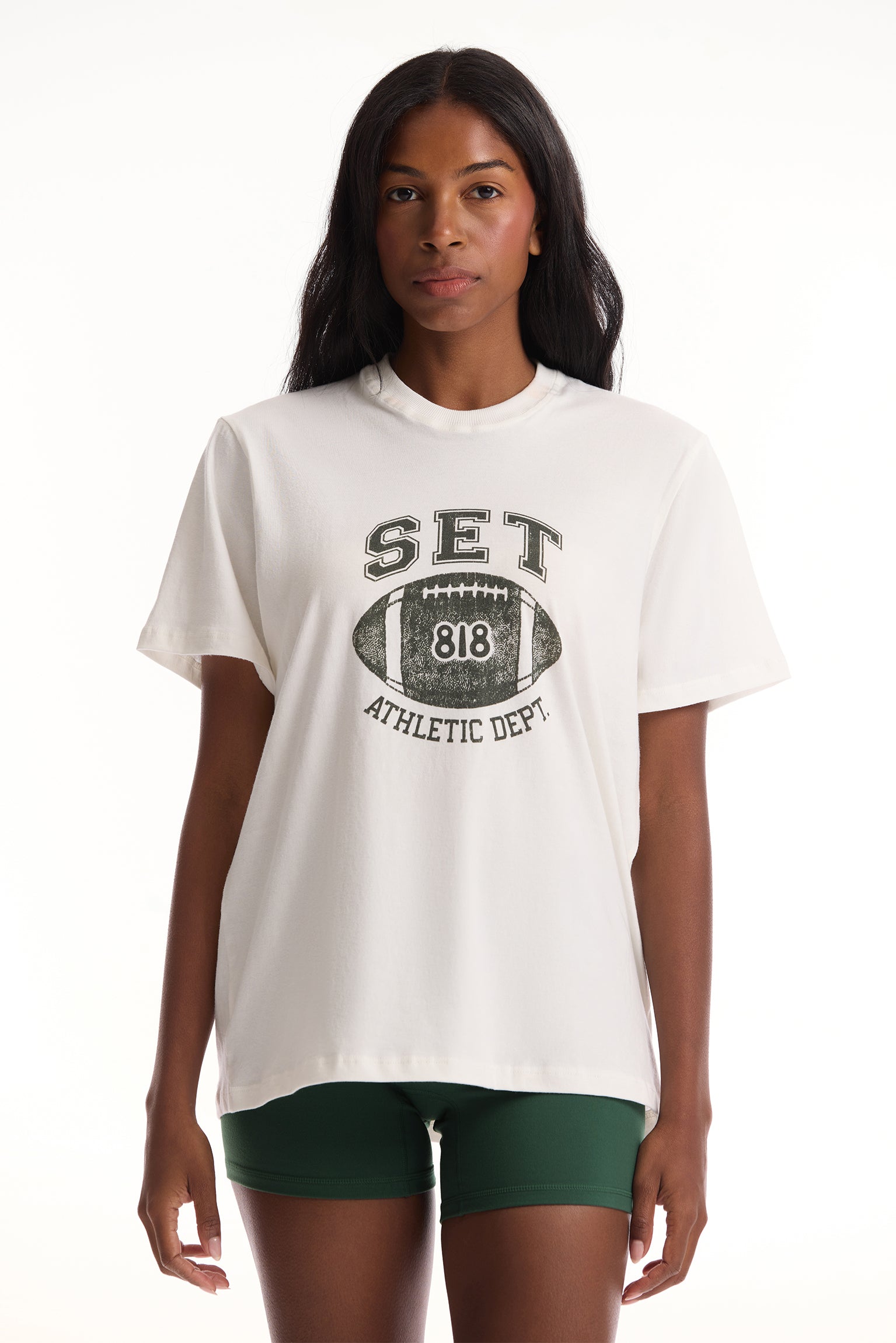 Woman wearing a white t-shirt with 'SET' and '818' graphic design on a white background <model-info>Autumn wears a size S and is 5’7½”, 25” waist, 32” bust.</model-info>