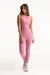 Woman wearing a pink athletic outfit on a white background