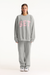 Person wearing a gray sweatshirt with 'SET' printed in pink on a white background