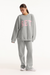 Person wearing a gray sweatshirt with 'SET' printed in pink on a white background