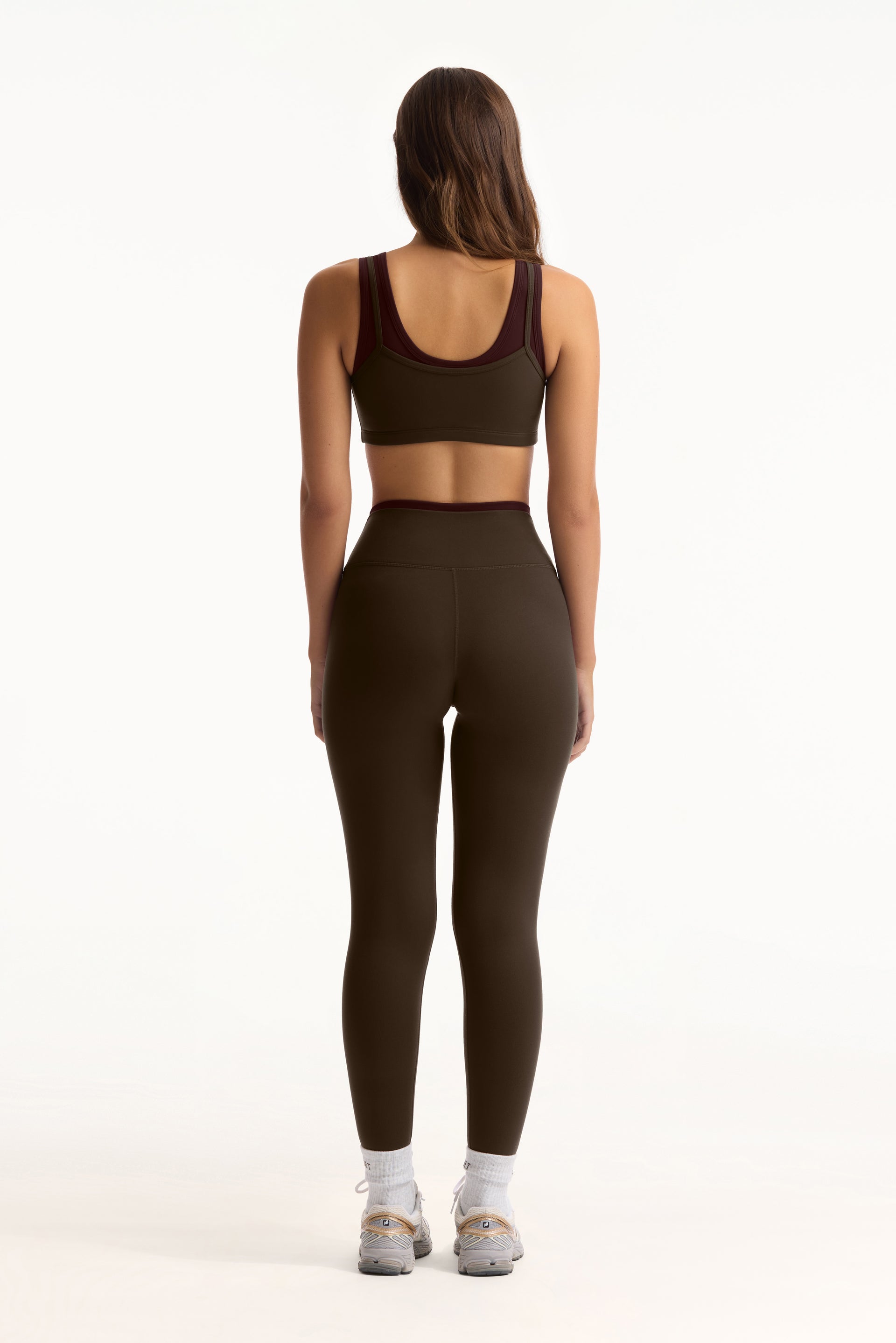 Person wearing a green athletic outfit on a white background