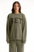 Person wearing a green sweatshirt with 'SET' text on a white background <model-info>Sophie wears a size L and is 5’9½”, 23” waist, 34CD bust.</model-info>