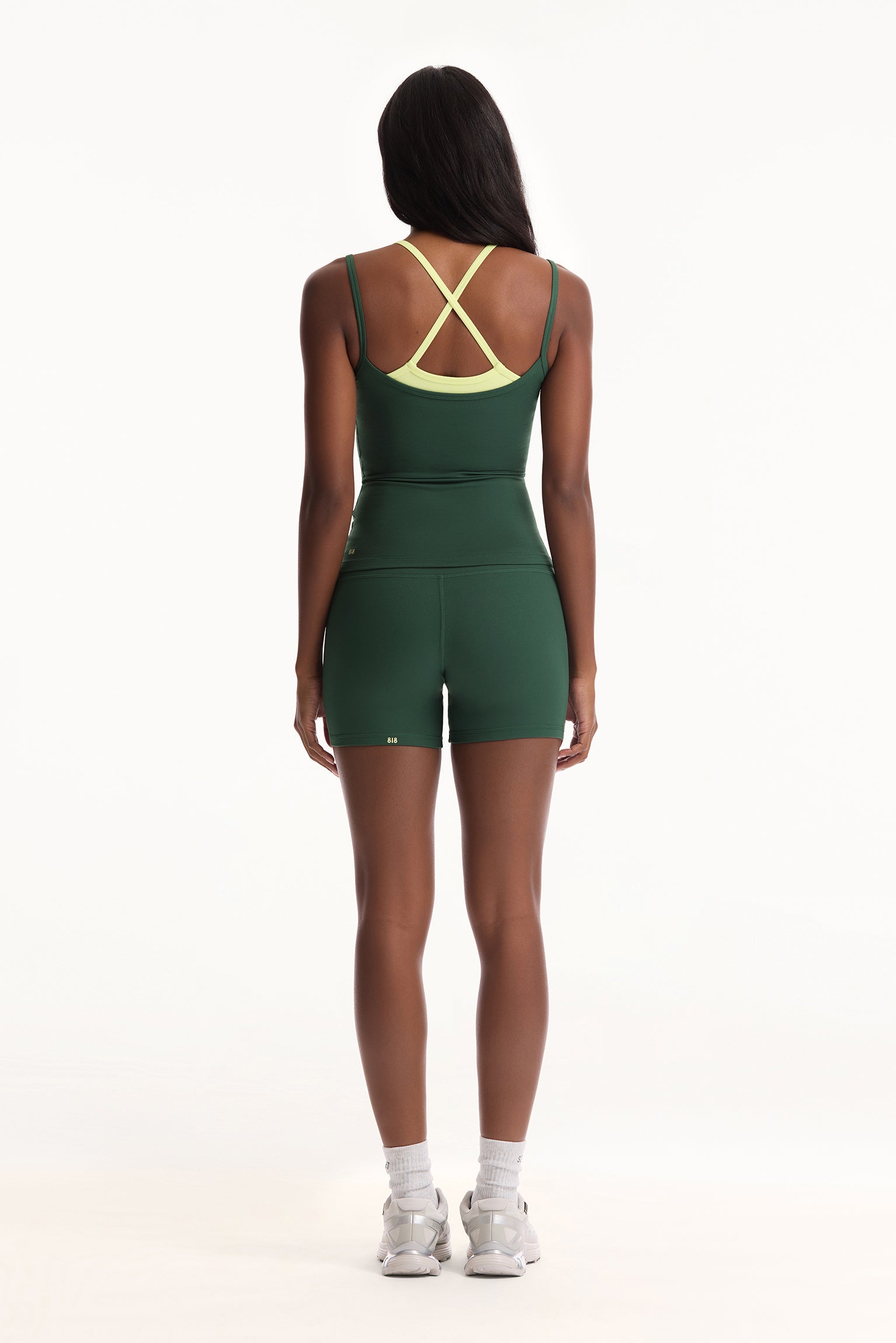 Person wearing a green and yellow sports outfit on a white background