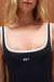 Black swimsuit with white trim and 'SET' branding on a neutral background