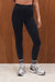 Person wearing black leggings with white stripes on a wooden background <model-info>Grace wears a size XS and is 5'8", 25" waist, 32" bust.</model-info>
