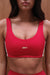 Red sports bra with 'SET' branding on a plain background