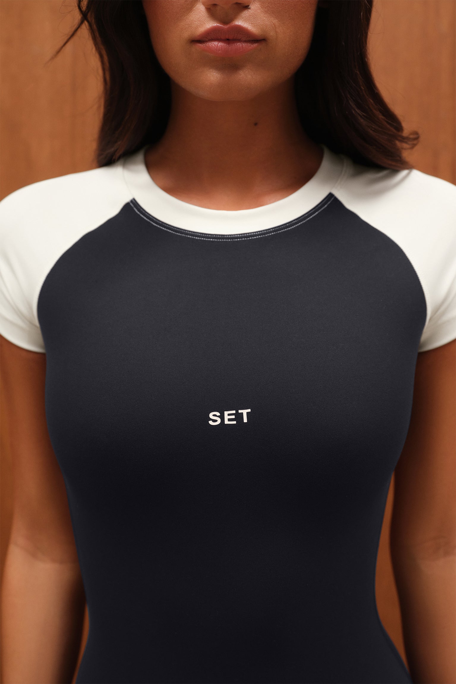 Person wearing a black and white shirt with 'SET' logo