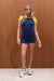 Woman wearing a blue and yellow athletic outfit against a wooden background <model-info>Grace wears a size XS and is 5'8", 25" waist, 32" bust.</model-info>